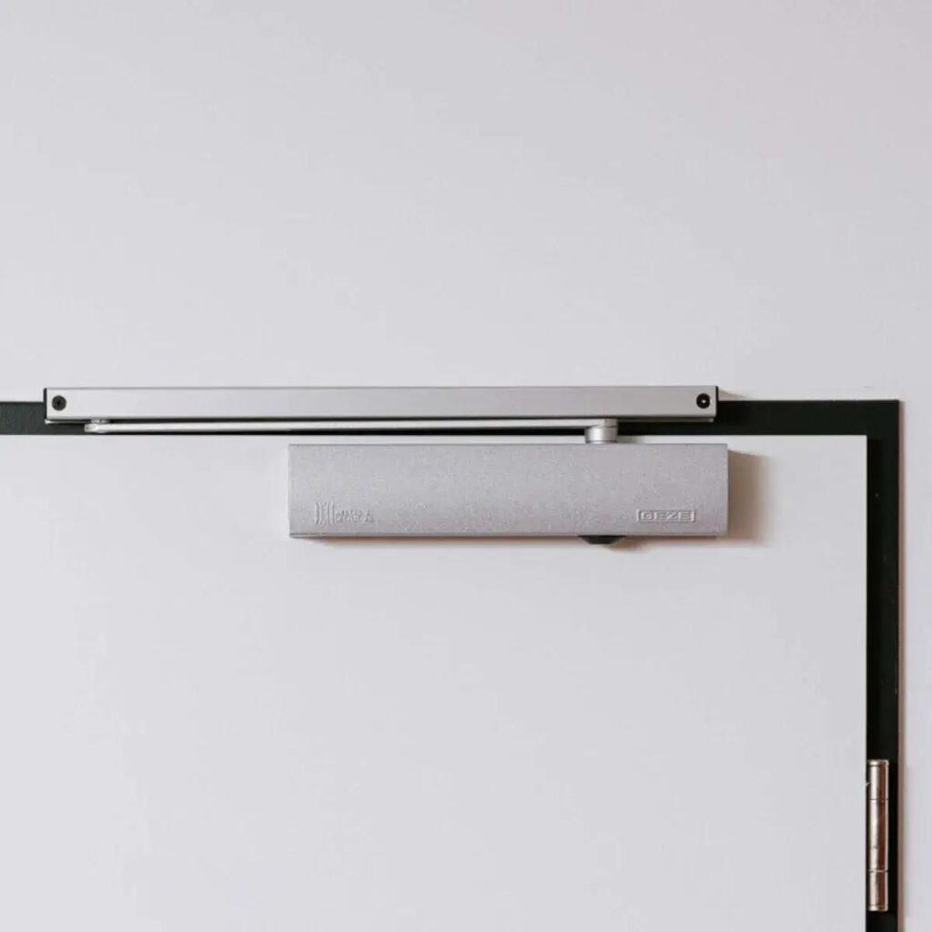 Commercial fire door fitted with self-closing mechanism to meet UK fire safety requirements