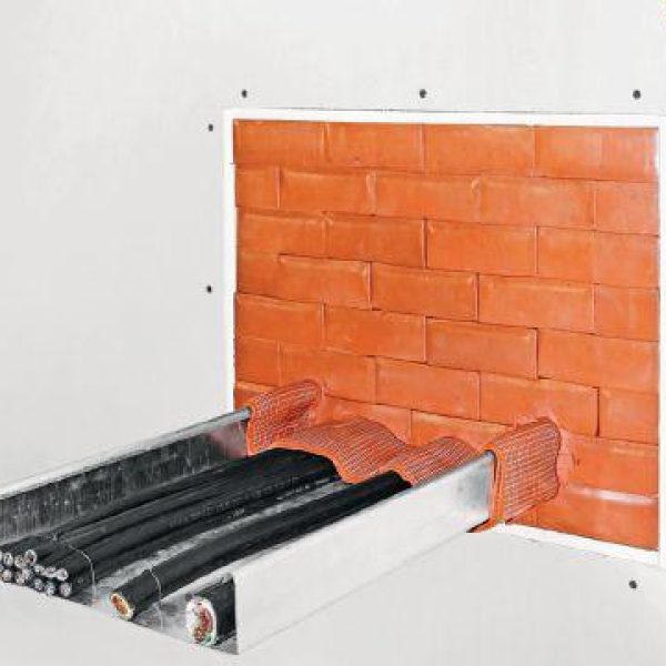 Passive fire protection system sealing cable penetrations through a fire-resistant wall to maintain compartmentation and fire safety compliance