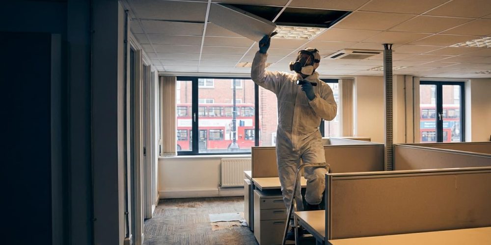 surveyor checking asbestos materials in commercial building
